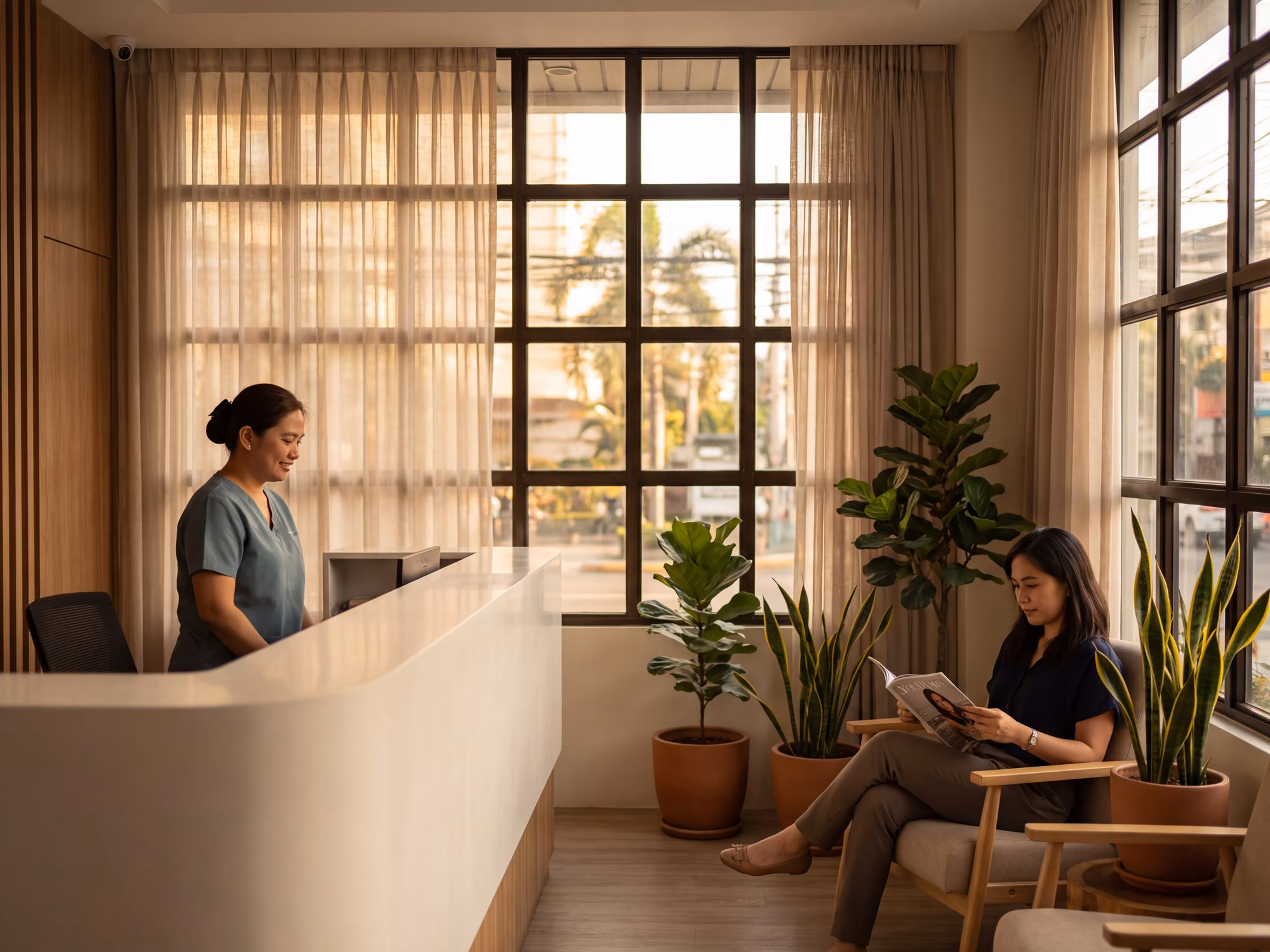 Receptionist at a private clinic in Metro Manila with a patient waiting in afternoon light