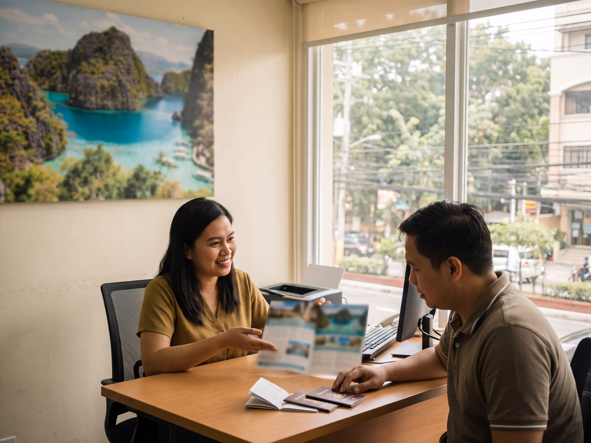 Travel consultant going through a brochure with a client in a Manila agency